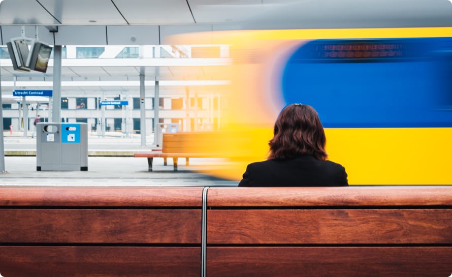 am Bahnhof sitzende Frau